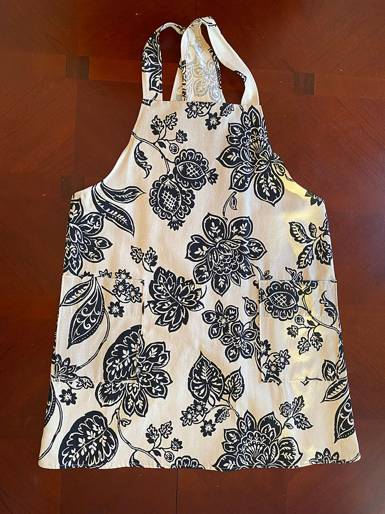 Black floral on cream apron